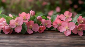 A pink apple blossoms on a wooden table with a blurred garden background. 2 photo