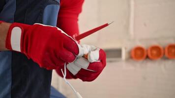 Electrician prepares materials for repair tasks in a workshop setting showcasing craftsmanship and attention to detail video
