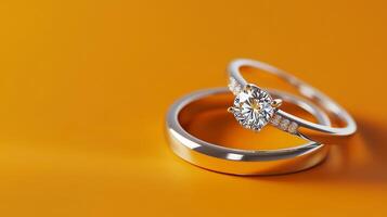 A wedding band, silver ring with diamond on an orange background. 11 photo