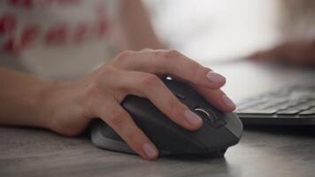 Woman using a computer mouse while working video