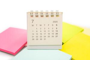 Mini Desk Calendar for JULY 2025 background. Calendar concept with 2025 JUL calendar. Sticky note. isolated on white background. photo