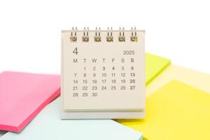 Mini Desk Calendar for APRIL 2025 background. Calendar concept with 2025 APR calendar. Sticky note. isolated on white background. photo