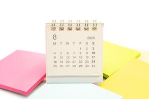 Mini Desk Calendar for AUGUST 2025 background. Calendar concept with 2025 AUG calendar. Sticky note. isolated on white background. photo