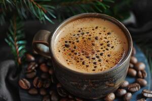 A rustic cup of freshly brewed coffee with frothy crema, sprinkled with cinnamon, surrounded by roasted coffee beans and pine branches. photo