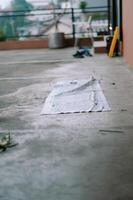 Rooftop renovation scene showcasing a discarded tarp and distant cityscape photo