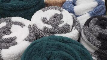 Cozy rolled towels in various colors displayed in a store video