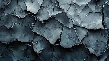 Monochromatic stone fragments form an abstract rock texture with rugged edges and varied gray tones, creating a visually striking composition. photo