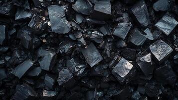 A pile of dark and shiny coal, a fossil fuel. The texture and dark color are emphasized, creating a striking visual. Close-up shot. photo