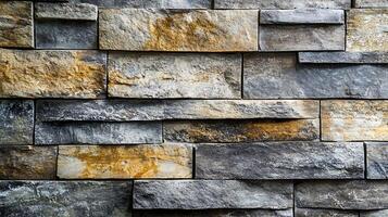 Close-up wall of rectangular stones of varying shades of gray, brown, and gold, creating a textured, rustic feel. photo