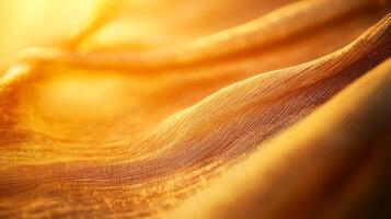 Abstract golden fabric with a warm glow creating gentle waves and subtle textures in this close-up view, ideal for artistic backgrounds. photo