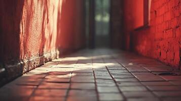Sunlit Alleyway A tranquil scene with sunlight casting shadows in a narrow passage between weathered red walls and tile floors. Serene ambiance. photo