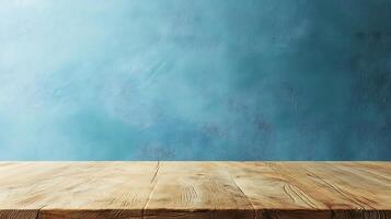 Rustic wooden table with an aged finish contrasts against a blue textured wall. A versatile setting for product presentation. photo