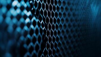 Abstract metal mesh with a blue hue. Intricate honeycomb pattern creating depth and texture. Great for backgrounds and overlays. photo