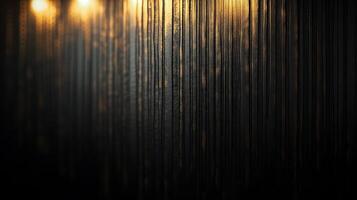 A dark, textured surface with vertical patterns and subtle golden highlights at the top, creating a sense of depth and subdued elegance. photo