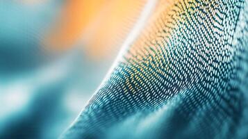 Intricate teal and gold patterned fabric texture. Detail showing weave and color gradient. Abstract textile shot. photo