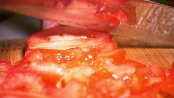 A knife cutting up a tomato on a cutting board video