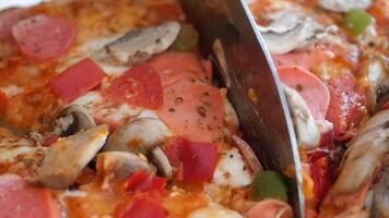 Enjoying freshly sliced pizza with toppings at a casual gathering video