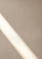 light and shadow on white wall, abstract background, closeup of photo. Sunbeam on Beige Wall photo