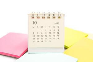 Mini Desk Calendar for OCTOBER 2025 background. Calendar concept with 2025 OCT calendar. Sticky note. isolated on white background. photo