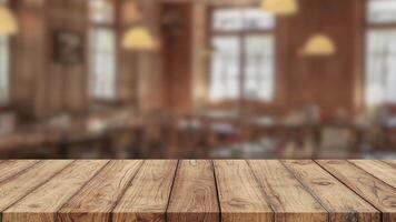 Empty old wood table top and blurred bokeh cafe and coffee shop interior background with vintage filter can used for display or montage your products video