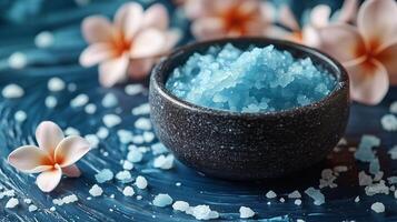 Blue sea salt in a bowl with flowers photo
