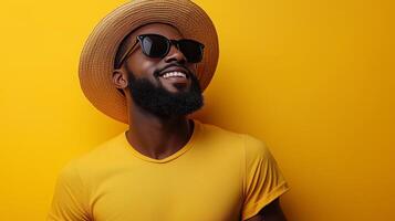 A man with a hat and sunglasses on a yellow background photo
