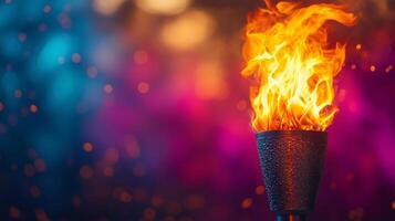 A burning torch is shown in front of a colorful background photo