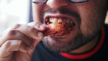 Enjoying spicy chicken wings at a local eatery in the afternoon video