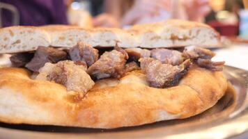 Enjoying traditional meat-filled flatbread at local eatery video