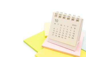Desk Calendar for OCTOBER 2025 background. Calendar concept with 2025 OCT calendar on Sticky note. isolated on white background. photo