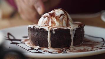 Indulging in a warm chocolate dessert topped with ice cream video