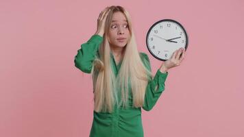 Confused woman with anxiety checking time on clock, running late to work, being in delay, deadline video