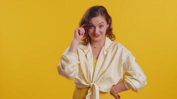 Displeased woman pointing at camera show stupid idiot gesture finger near head dumb insane plan idea video