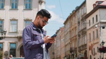 Tourist traveler indian man using looking smartphone search a way on map in mobile navigator app video