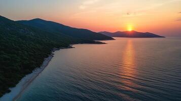 shot of a seashore with hills on the background at sunset photo