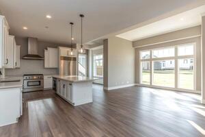 Modern open plan kitchen and dining area with large windows providing natural light photo