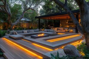 Modern backyard patio with fire pit and integrated lighting illuminating seating area at dusk photo