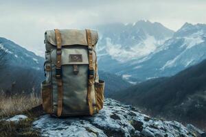 Backpack standing on rock overlooking mountain valley photo