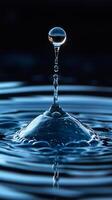 Water drop splashing and creating a column in the air photo