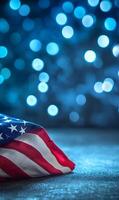 Patriotic tribute american flag in subdued lighting with abstract sparkling blue background photo