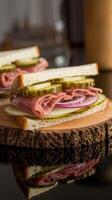 A sandwich with meat, pickles and onions on a wooden board photo