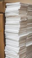 A stack of papers in a box photo