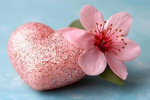 Sparkling Pink Heart with Cherry Blossom on Soft Blue Background for Romantic Design photo