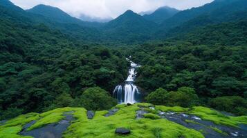 Serene Waterfall Cascading Through Lush Green Mountain Forest Landscape photo