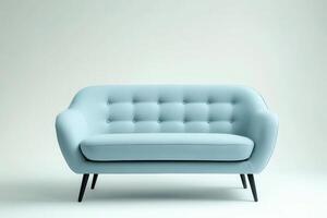 A modern light blue sofa with button detailing and black legs, designed for comfort and style. photo
