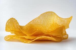 A stack of golden, crispy snacks with a wavy texture. photo