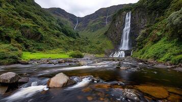 Majestic Waterfall cascading down lush green cliffs into a tranquil river Scenic landscape photo