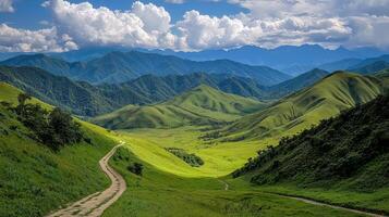 Scenic Winding Dirt Road Through Lush Green Mountains and Valley Landscape under a Blue Sky with Fluffy White Clouds photo