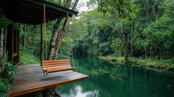 Serene Wooden Swing Over Calm River in Lush Green Forest Tranquil Nature Scene Peaceful Vacation Getaway photo
