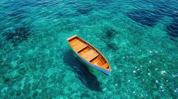 Serene Wooden Rowboat Floating on Crystal Clear Turquoise Water Calm Ocean Scene Summer Vacation photo